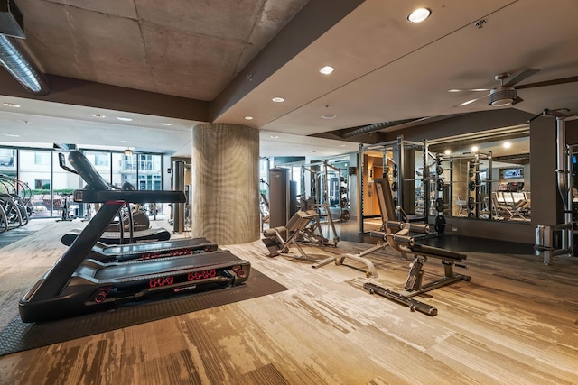 workout area featuring ceiling fan and wood finished floors