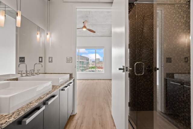 bathroom featuring ceiling fan, hardwood / wood-style floors, vanity, and a shower with shower door