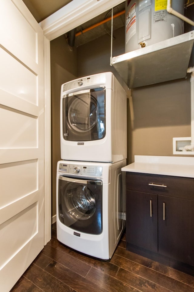 washroom with wood tiled floor, cabinet space, and stacked washing maching and dryer