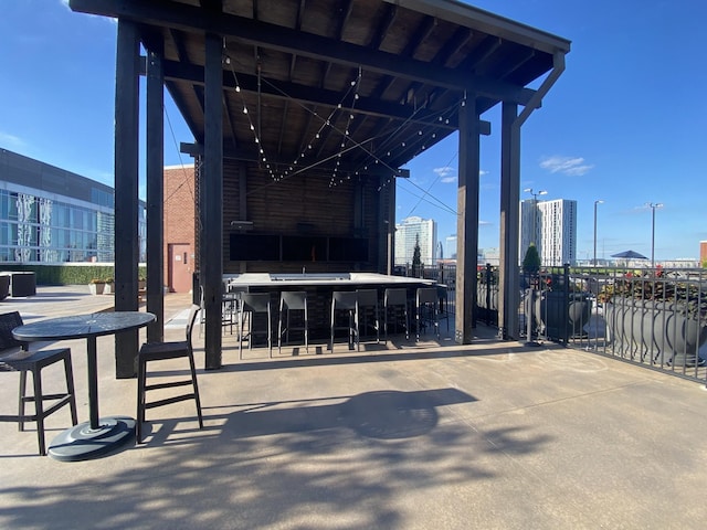 view of patio / terrace featuring exterior bar and a city view