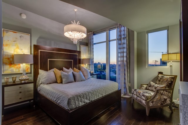 bedroom featuring a chandelier, dark wood-style flooring, and floor to ceiling windows