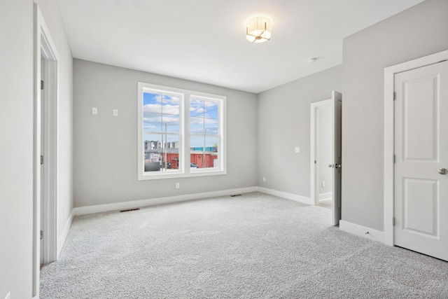 unfurnished bedroom with light colored carpet