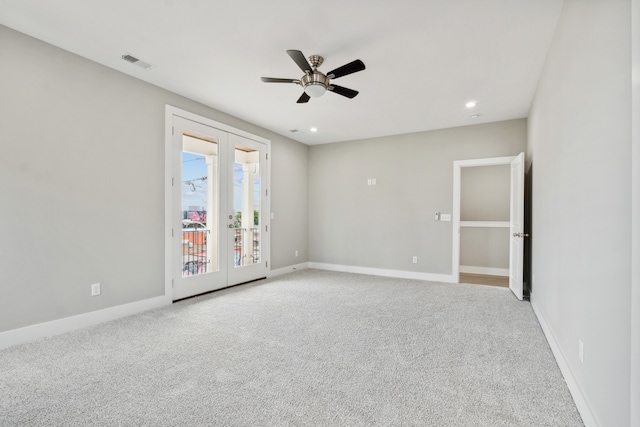 spare room featuring ceiling fan, carpet flooring, and french doors