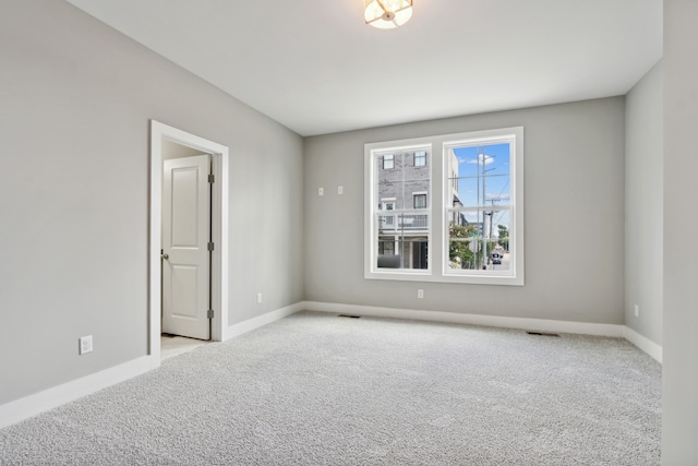 empty room featuring light colored carpet