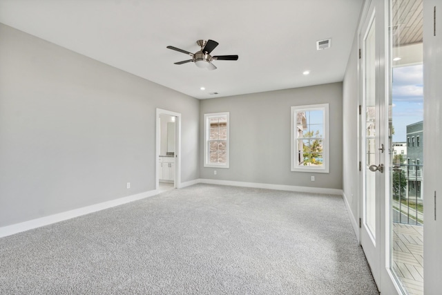 carpeted empty room with a ceiling fan, recessed lighting, visible vents, and baseboards