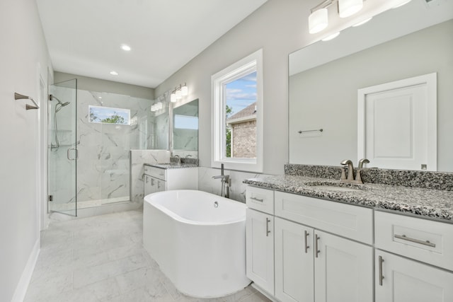 bathroom featuring plus walk in shower, vanity, and tile patterned floors