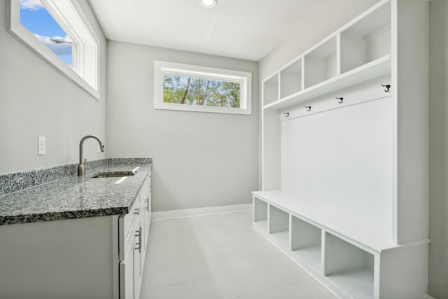 mudroom with sink and light tile patterned floors