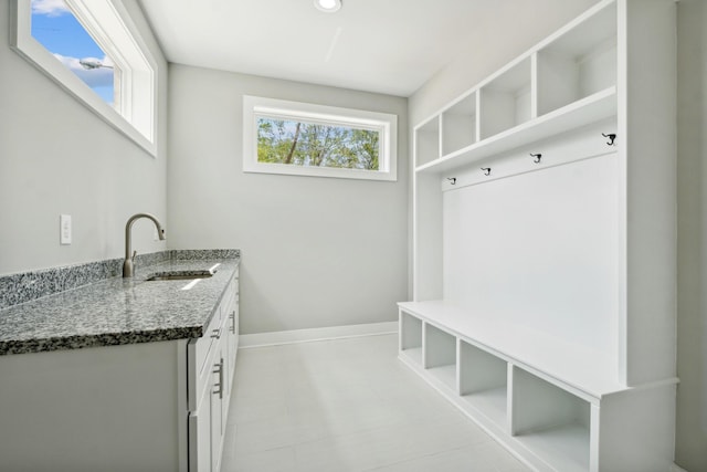 mudroom featuring a sink and baseboards