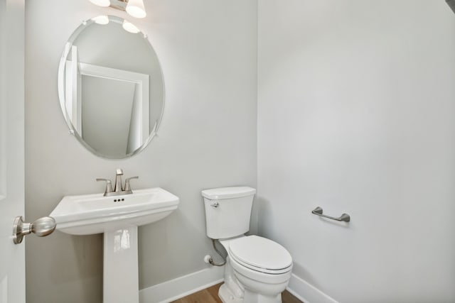 bathroom featuring toilet and hardwood / wood-style floors