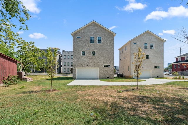 back of property featuring a yard and a garage