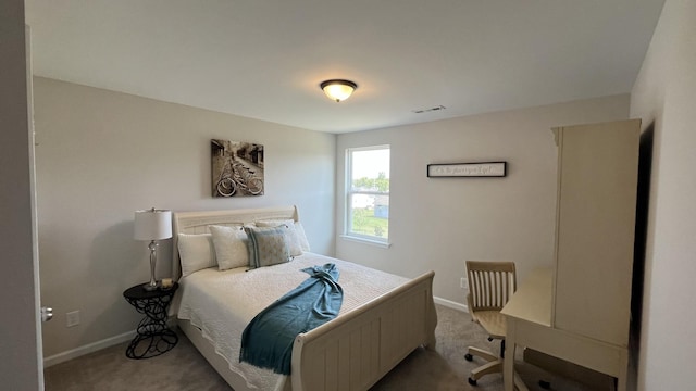 bedroom with light carpet, visible vents, and baseboards