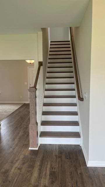 stairs with baseboards and wood finished floors