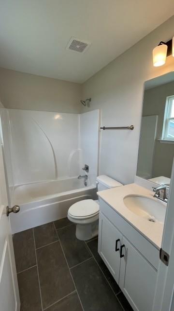 full bathroom featuring tile patterned floors, washtub / shower combination, vanity, and toilet