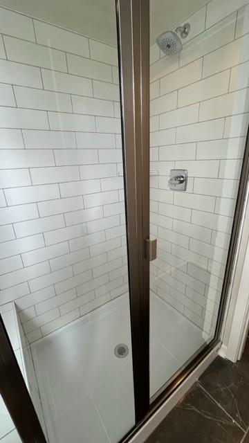 bathroom featuring tile patterned floors and a shower with door