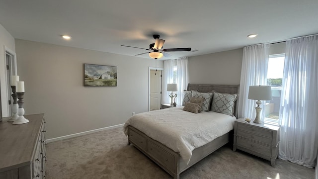 bedroom with a ceiling fan, recessed lighting, light colored carpet, and baseboards