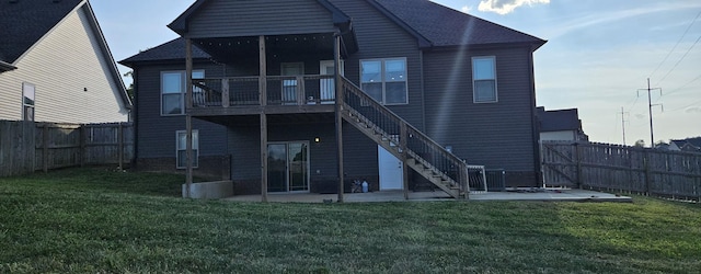 back of house with a patio, a fenced backyard, roof with shingles, stairs, and a yard