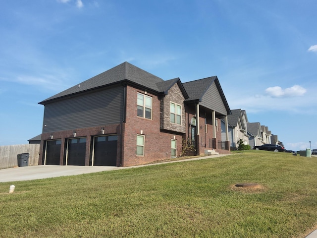 view of side of home with concrete driveway, a lawn, an attached garage, fence, and brick siding