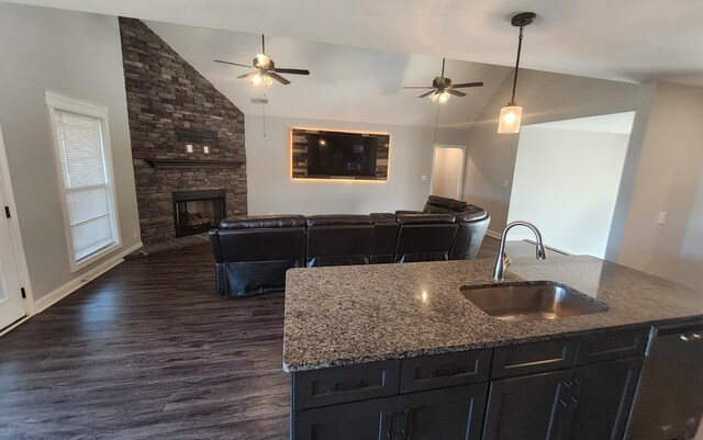 kitchen featuring sink, a fireplace, dark hardwood / wood-style floors, and ceiling fan