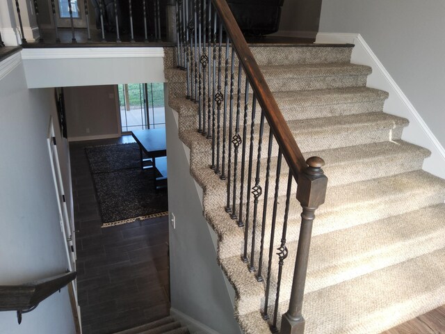 staircase with hardwood / wood-style flooring