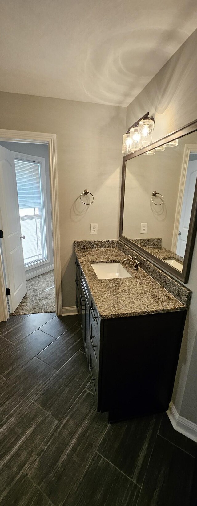 bathroom featuring tile patterned flooring and vanity