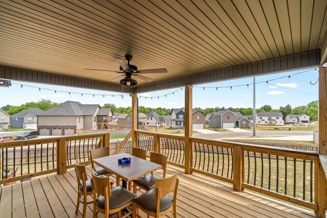 deck featuring ceiling fan and a garage