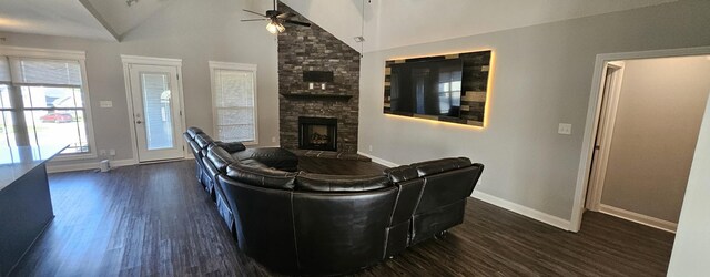 living room featuring a fireplace, brick wall, ceiling fan, and dark hardwood / wood-style floors