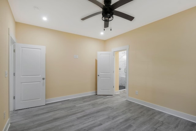 unfurnished room featuring recessed lighting, wood finished floors, a ceiling fan, and baseboards