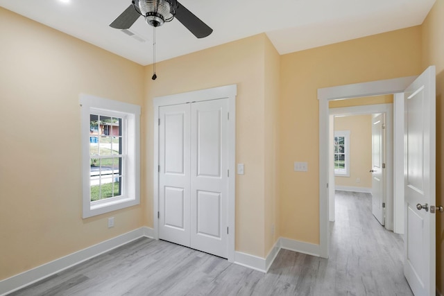 unfurnished bedroom featuring light wood-style floors, visible vents, and baseboards