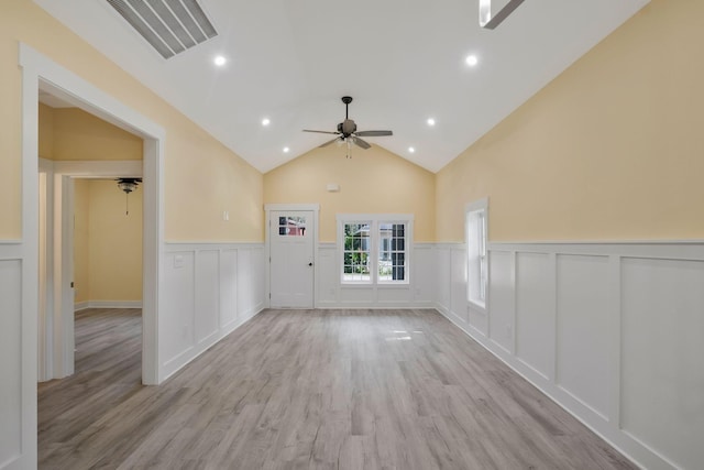 spare room featuring light wood finished floors, visible vents, lofted ceiling, ceiling fan, and recessed lighting