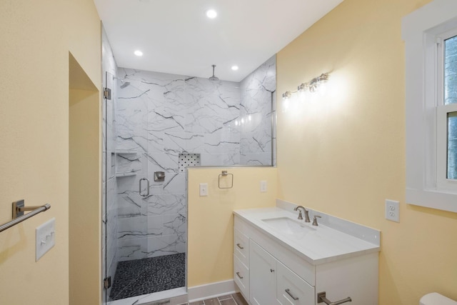 full bathroom featuring recessed lighting, a marble finish shower, and vanity