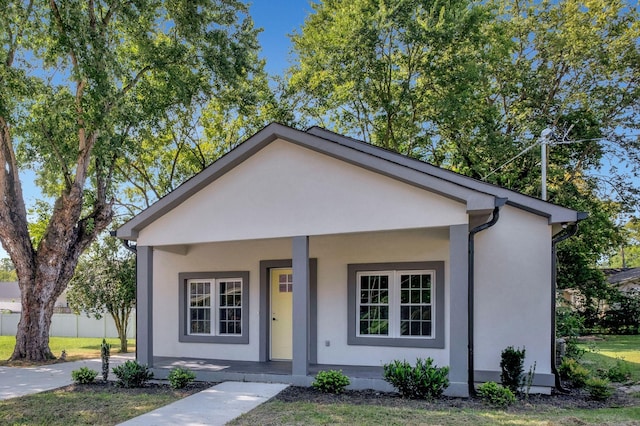 view of front of home with a porch and stucco siding