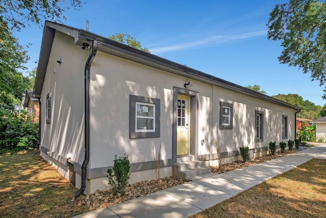 view of front of house with entry steps and stucco siding