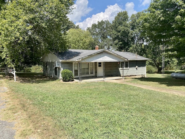 single story home featuring a chimney and a front yard