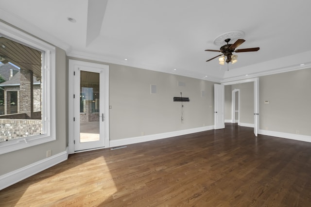 unfurnished living room with baseboards, ceiling fan, ornamental molding, dark wood-type flooring, and recessed lighting