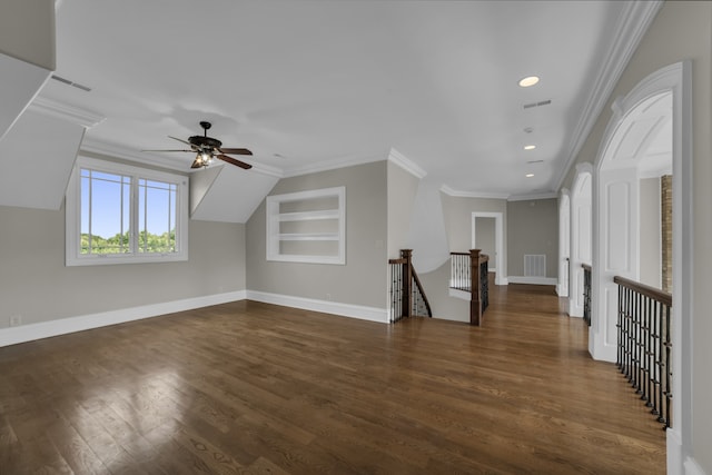 bonus room featuring dark wood-type flooring, built in features, and ceiling fan