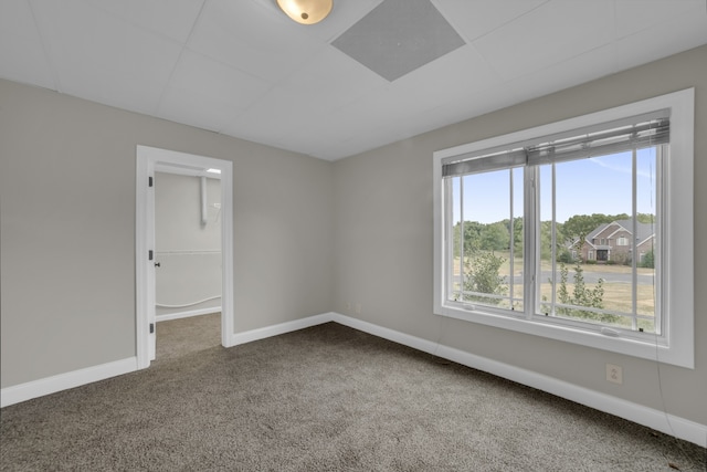 carpeted empty room with baseboards