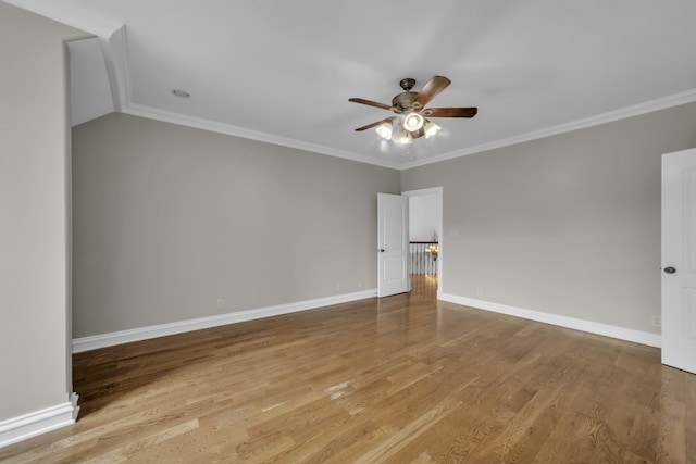 empty room with light wood finished floors, ceiling fan, baseboards, and crown molding