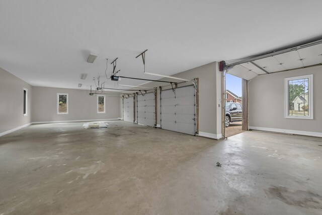 garage with a garage door opener and baseboards