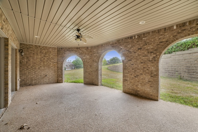 view of patio / terrace with ceiling fan and fence