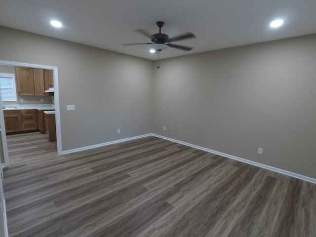 empty room with dark wood-style floors, baseboards, a ceiling fan, and recessed lighting