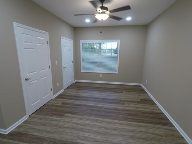 unfurnished room featuring dark wood-style flooring, recessed lighting, a ceiling fan, and baseboards