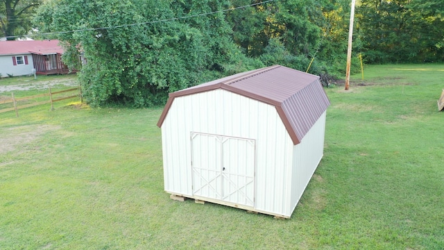 view of shed featuring fence