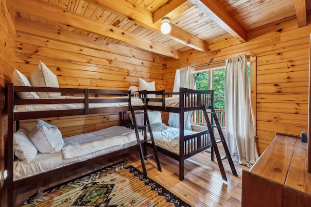 bedroom featuring hardwood / wood-style flooring, beamed ceiling, and wooden ceiling