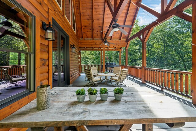 wooden deck featuring ceiling fan and area for grilling