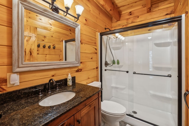 bathroom with wooden walls, vanity, walk in shower, and toilet