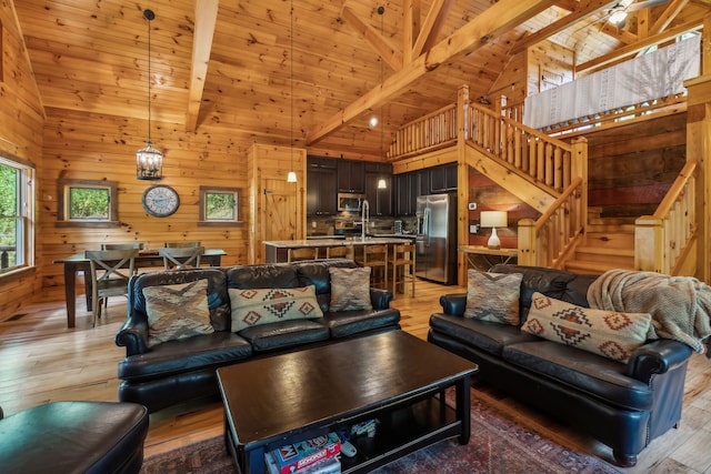 living room with beamed ceiling, hardwood / wood-style flooring, wood ceiling, and wooden walls