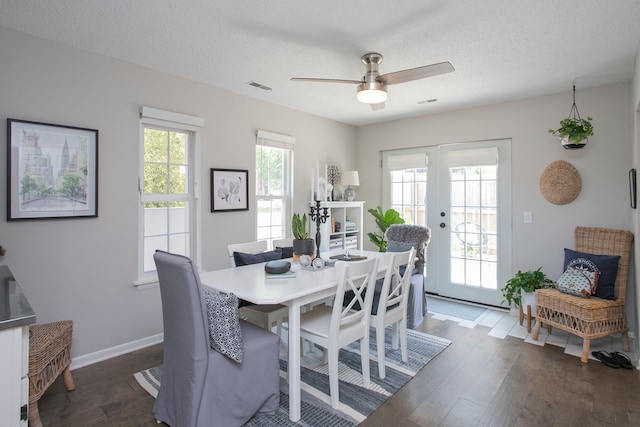 dining area featuring ceiling fan, french doors, wood-type flooring, and a textured ceiling