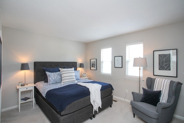 carpeted bedroom with a textured ceiling