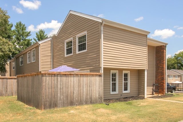 view of property exterior with a yard