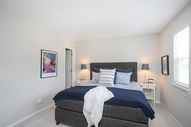 bedroom featuring light carpet